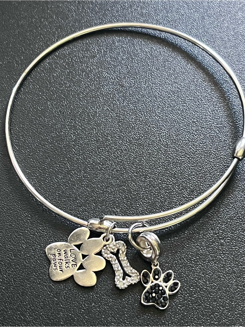 925 sterling silver expandable bangle with dog bone + paw charms.